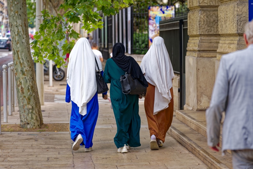 Rear,View,Of,Three,Young,Muslim,Women,With,Traditional,Abaja