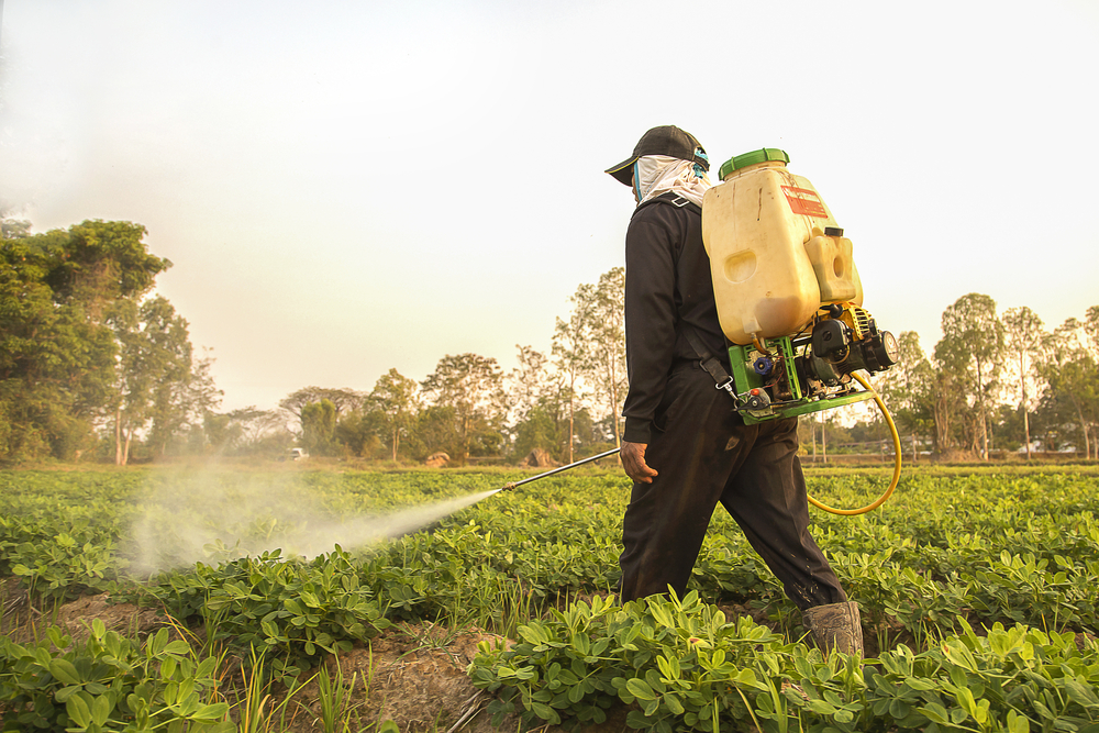 Farmer,Spraying,Pesticide,During,Sunset,Time