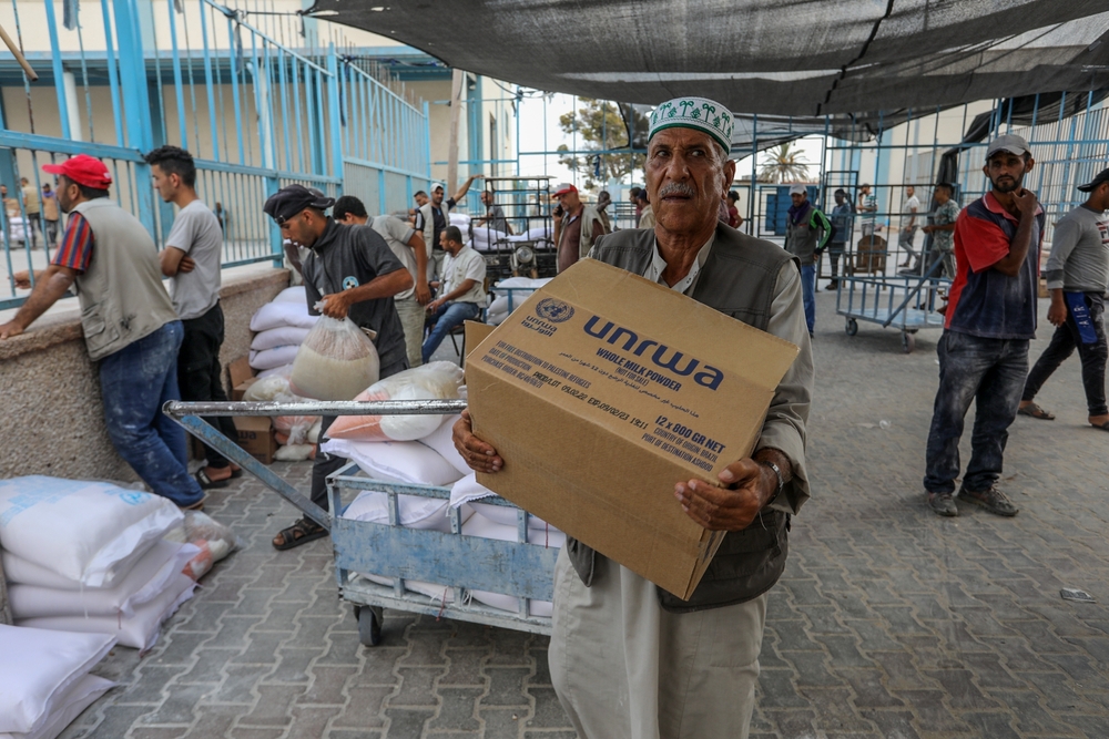 Palestinians,Receive,Their,Food,At,The,Aid,Distribution,Centre,Run