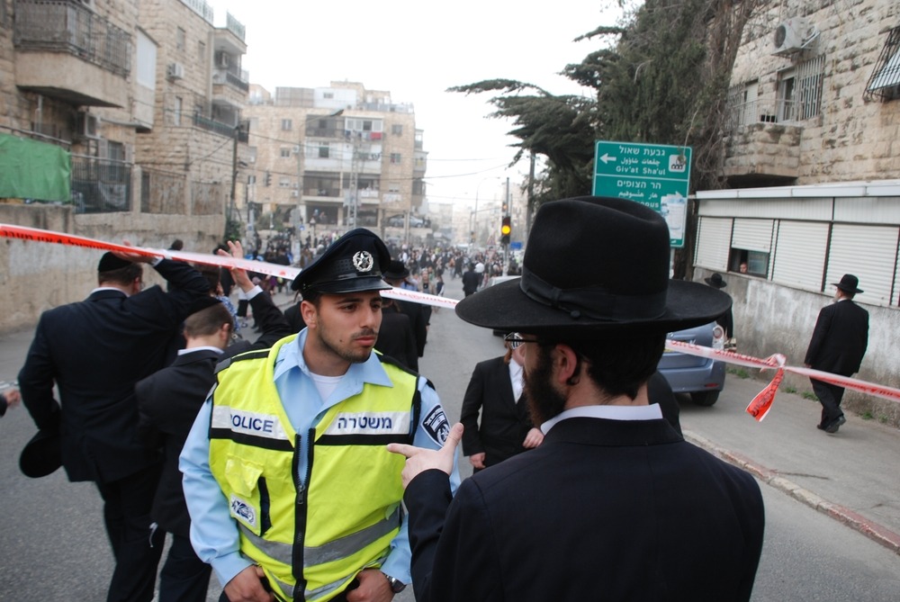 An,Israeli,Policeman,Argues,With,Ultra Orthodox,At,A,Demonstration,Against