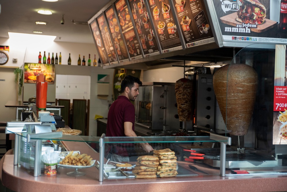 Berlin/germany ,09/06/2019:,A,Man,Tends,A,Restaurant,Selling,Döner,Kebabs.